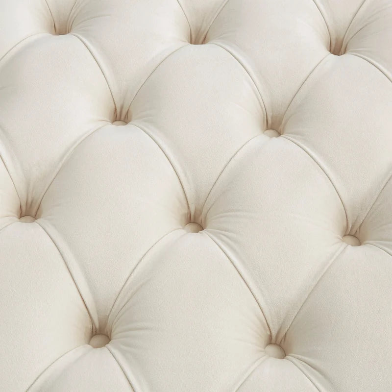 Pouf rond capitonné en velours et finition dorée